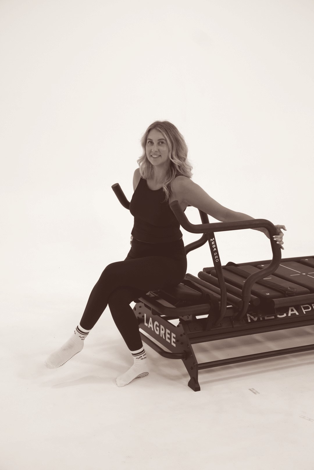 Krista seated on the Megaformer